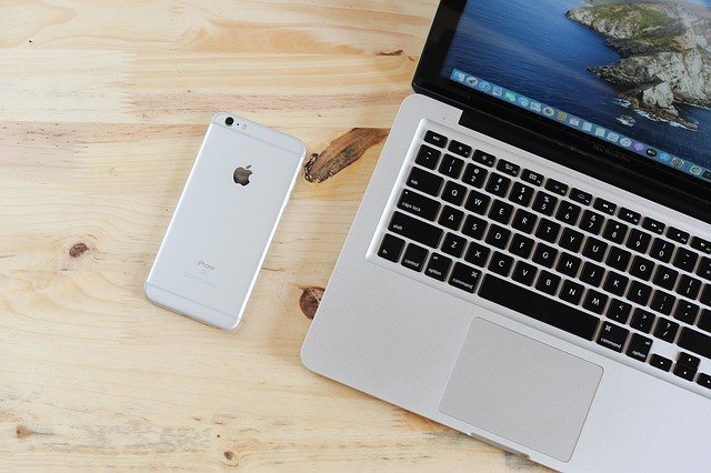 Apple MacBook laptop with smartphone on a desk